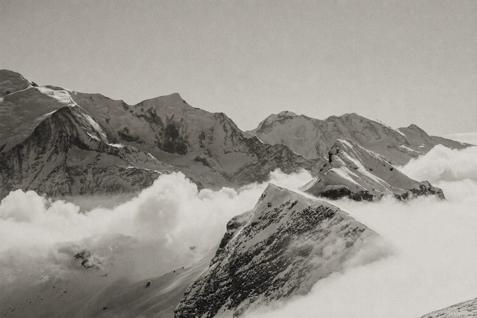 Mountain peaks rising above a layer of cloud